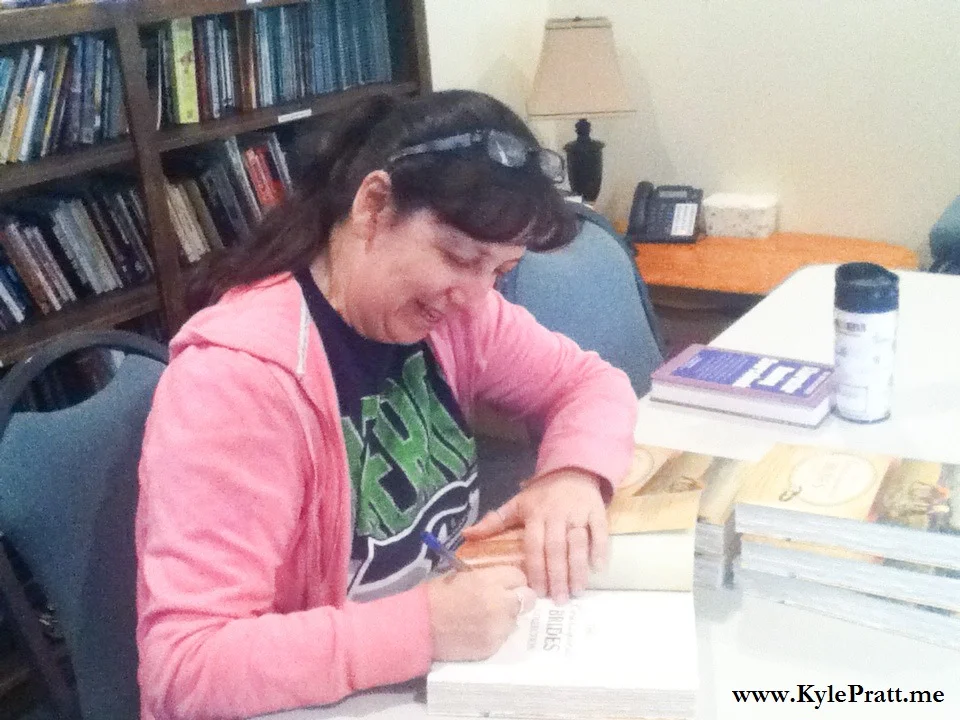 Debby Lee signs a copy of The Courageous Brides