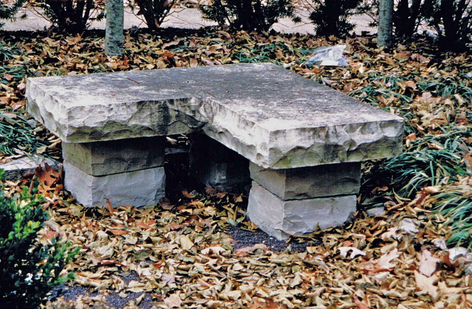 Limestone Corner Bench in a Sunken Garden