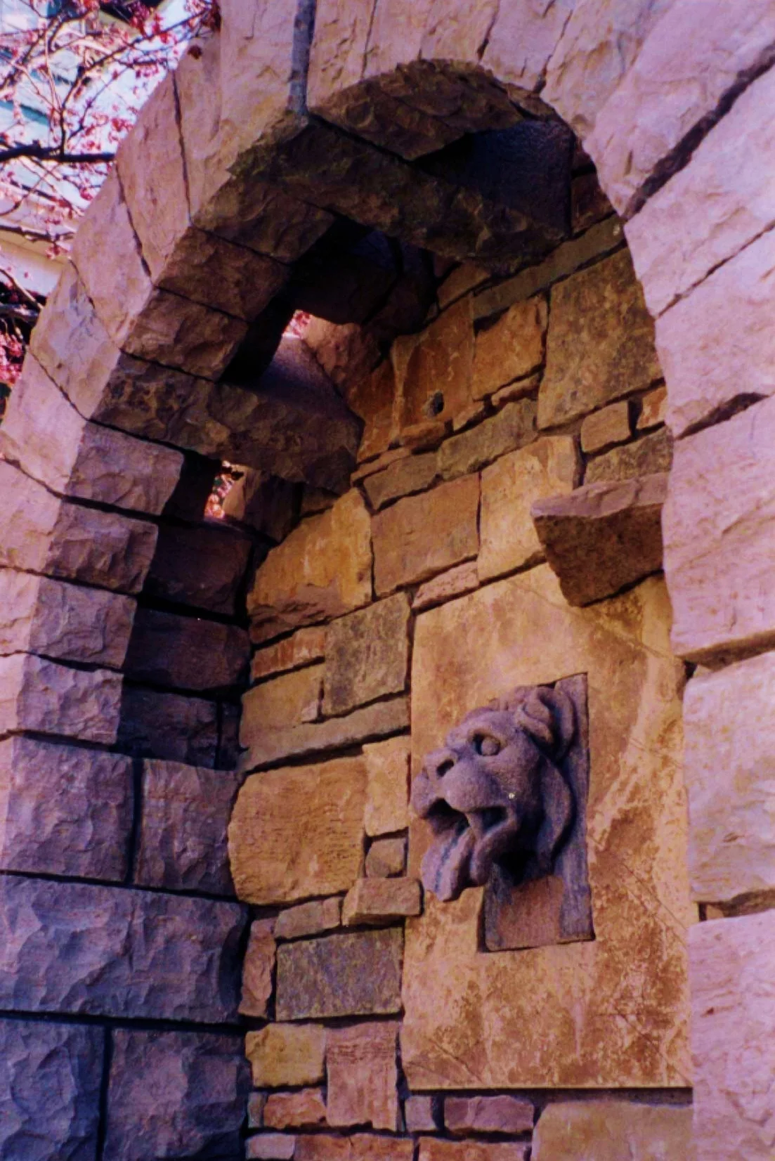 Stone arch with sky lights over a gargoyle fountain. Lee Lindsey Stone Works, St. Louis, MO