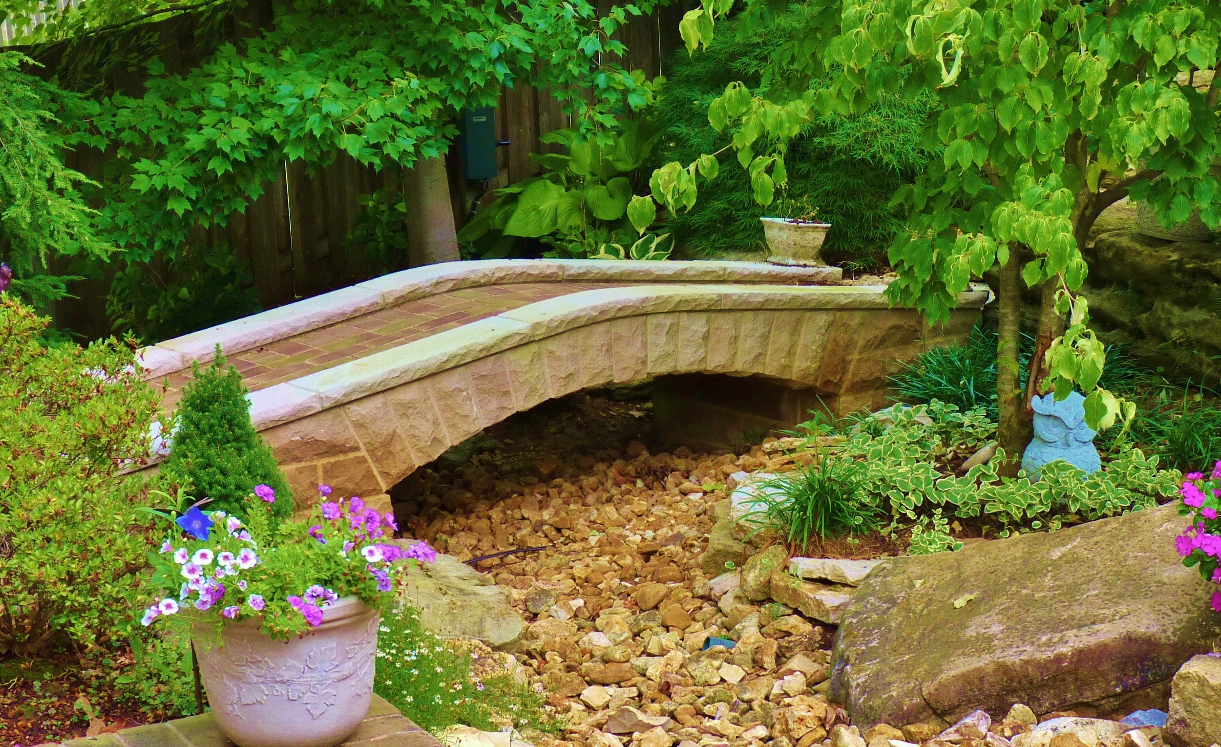 Stone arch bridge with a recessed brick path.     Stone Works by Lee Lindsey St. Louis, MO