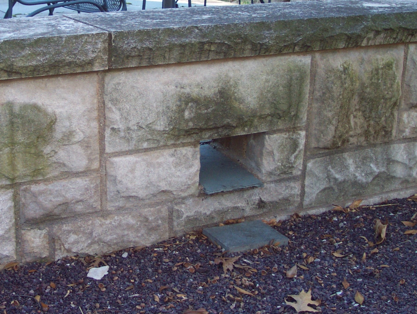 Slate Scupper Through a Limestone Sitting Wall