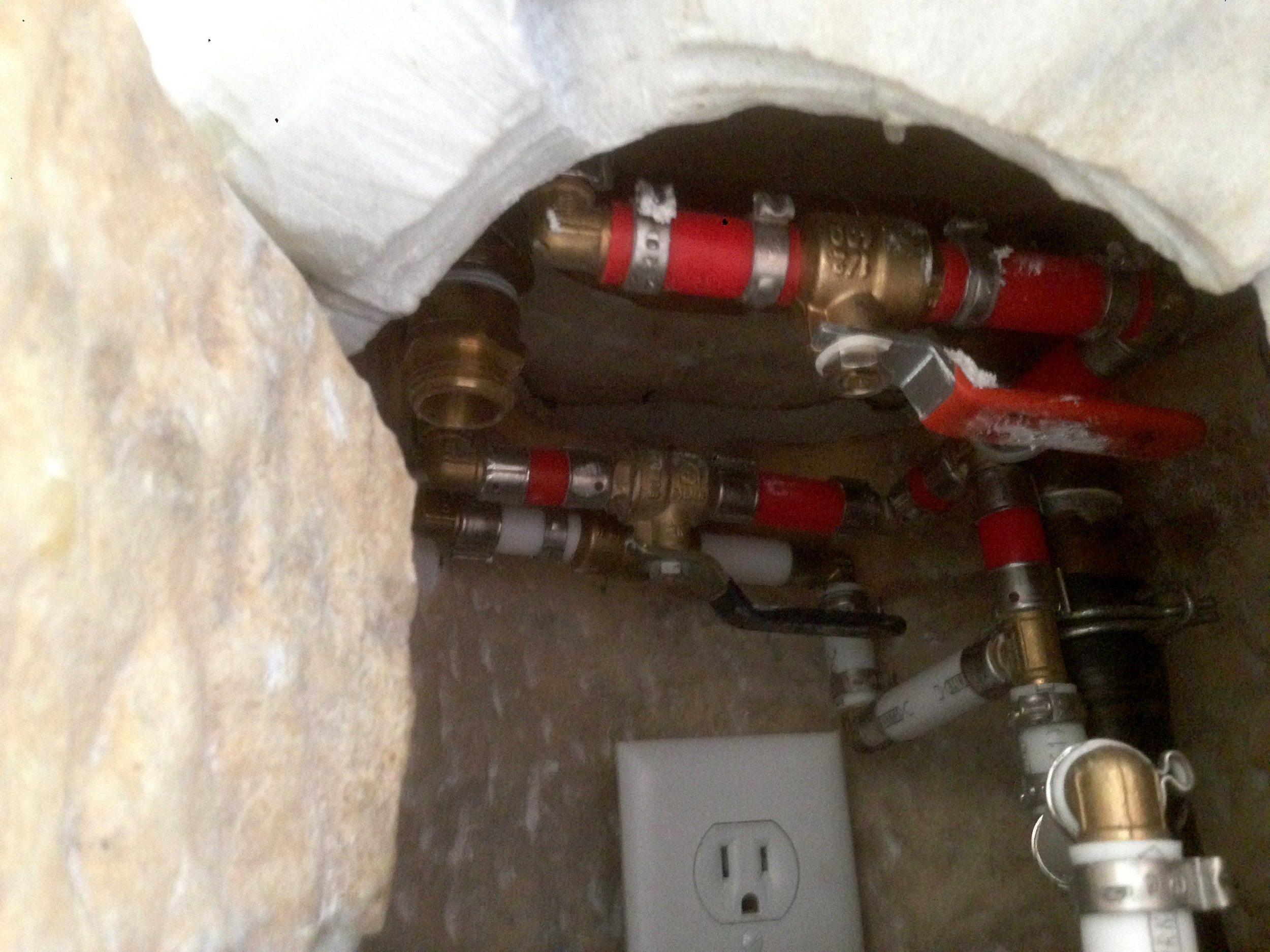  A peek inside the fountain base at the adjustable valves. Later a pump, filter and drain pipes were added. 
