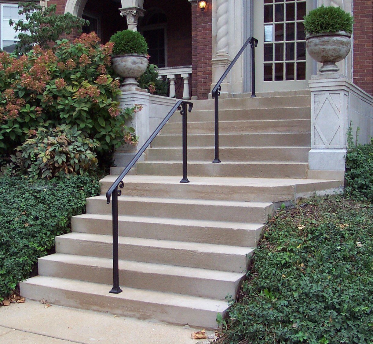  Finished project.  Oh … Yes, we installed new handrails too. Often I see handrails installed by drilling a hole in the masonry then grouting the steel tubing into the hole. A few years later the tubing will rust and break the stone or concrete. Thes