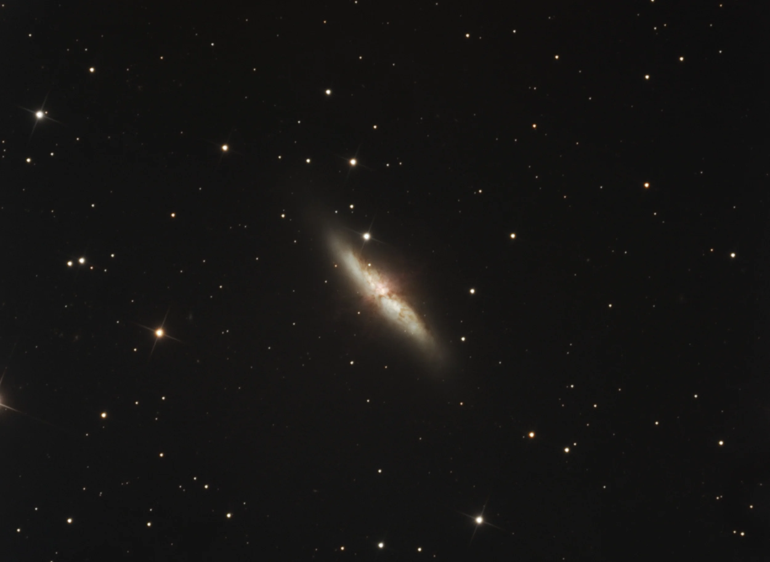 Messier 82 (also known as the Cigar Galaxy or M82) is a starburst galaxy about 12 million light-years away in the constellation Ursa Major. It is about five times more luminous than the whole Milky Way and one hundred times more luminous than our galaxy's center. The starburst activity is thought to be triggered by interaction with neighboring galaxy M81, and M82 is a member of the M81 Group. As the closest starburst galaxy to our own, M82 is the prototypical example of this type of galaxy. Type a supernova, was observed in the galaxy on 21 January 2014, see 2014 supernova . In 2014, in studying M82, scientists discovered the brightest pulsar yet known, designated M82.