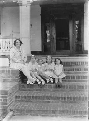 Henriette Bassett with her daughters on the porch at Pineola