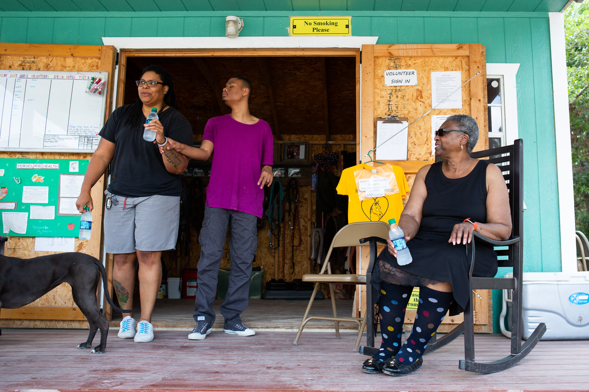 Davis sits on the porch as she watches her daughter Felicia lead her adopted son Matthew out of the storage room after a horse therapy session. Matthew is visually impaired, with other special needs, and Gwen feels that an alternative approach to therapy has helped him immensely.