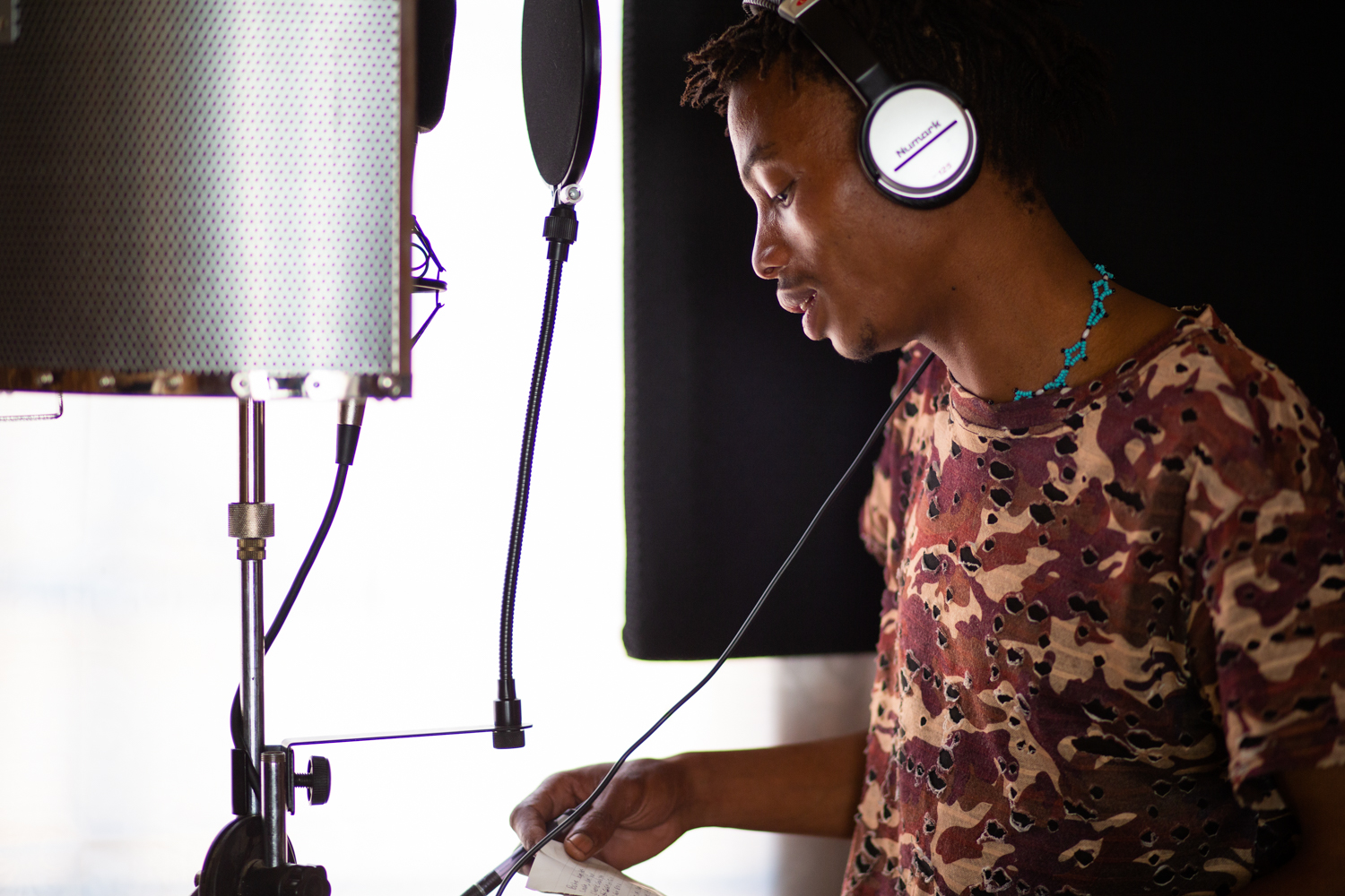 Alphynho prepares to record a new song during a recording session in Ghanzi. He sings in Naro, the native language of the San in the region west of the Kalahari, and uses many traditional musical elements. He hopes to preserve and celebrate his culture and language through his music.