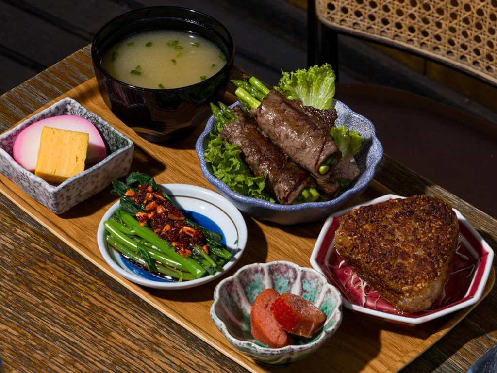 Onigiri set featuring wagyu beef wrapped around asparagus, kissed by the grill for maximum umami. A premium bite with satisfying depth.