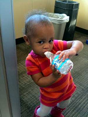 A Scholar's child takes a water break during a training.
