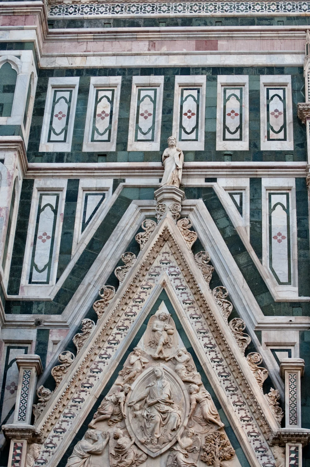 The cathedrals original facade was dismantled in 1588 and replaced with a colorful Neo-Gothic facade clad with white, green, and pink Tuscan marble.
