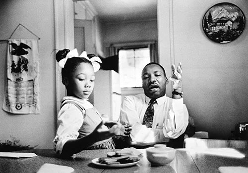 Dr. King with his youngest daughter Yolanda. Reminds us that we need to engage verbally with our children and get down on their level to remain relevant and relatable.