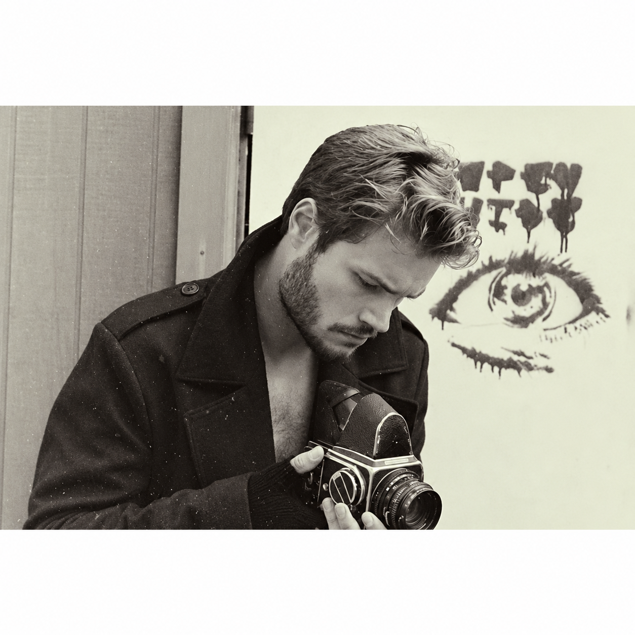 Man with camera and eye artwork.png
