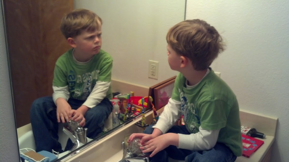 AJ exploring self in mirror. 