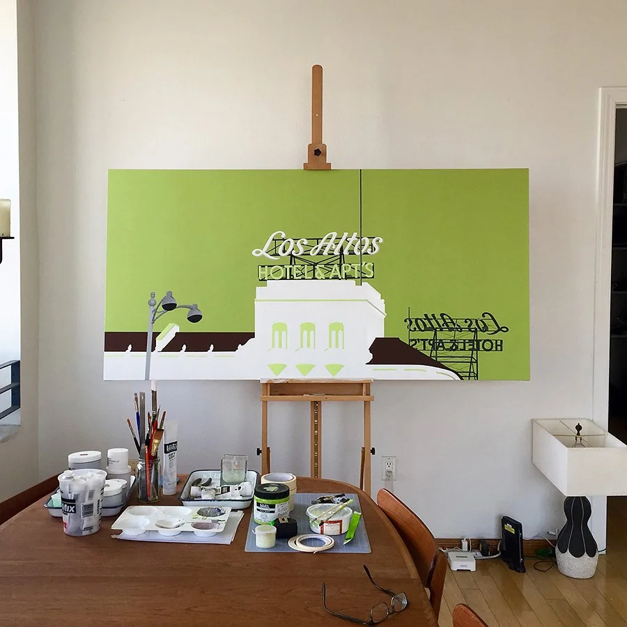 Painting of the Los Angeles city sign for a mural project, placed on an easel in a room with painting supplies on a table.
