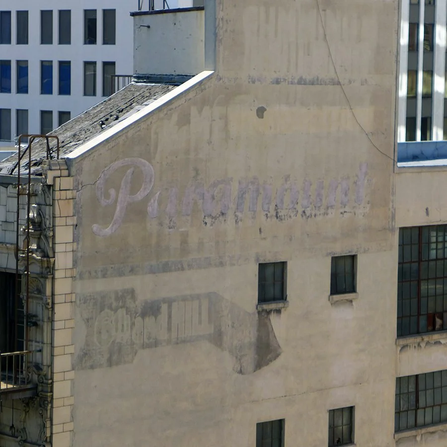 Faded vintage advertisement painted on the side of a building, with the word 'Palmolive' partially visible.