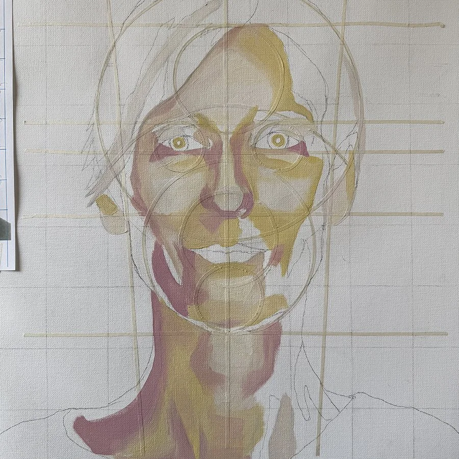 A work-in-progress portrait of a smiling woman with light-colored hair, with grid and circle guidelines overlaid on the canvas.
