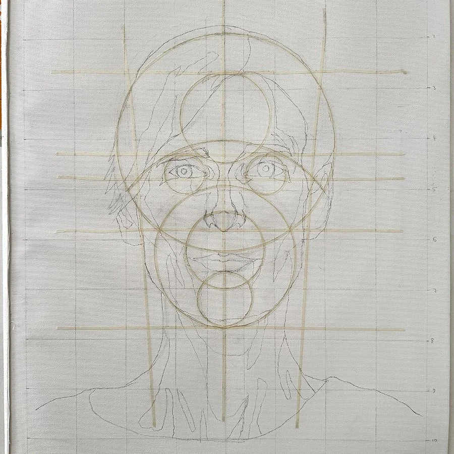 Sketch of a woman's face with guiding circles and grid lines for drawing proportions.