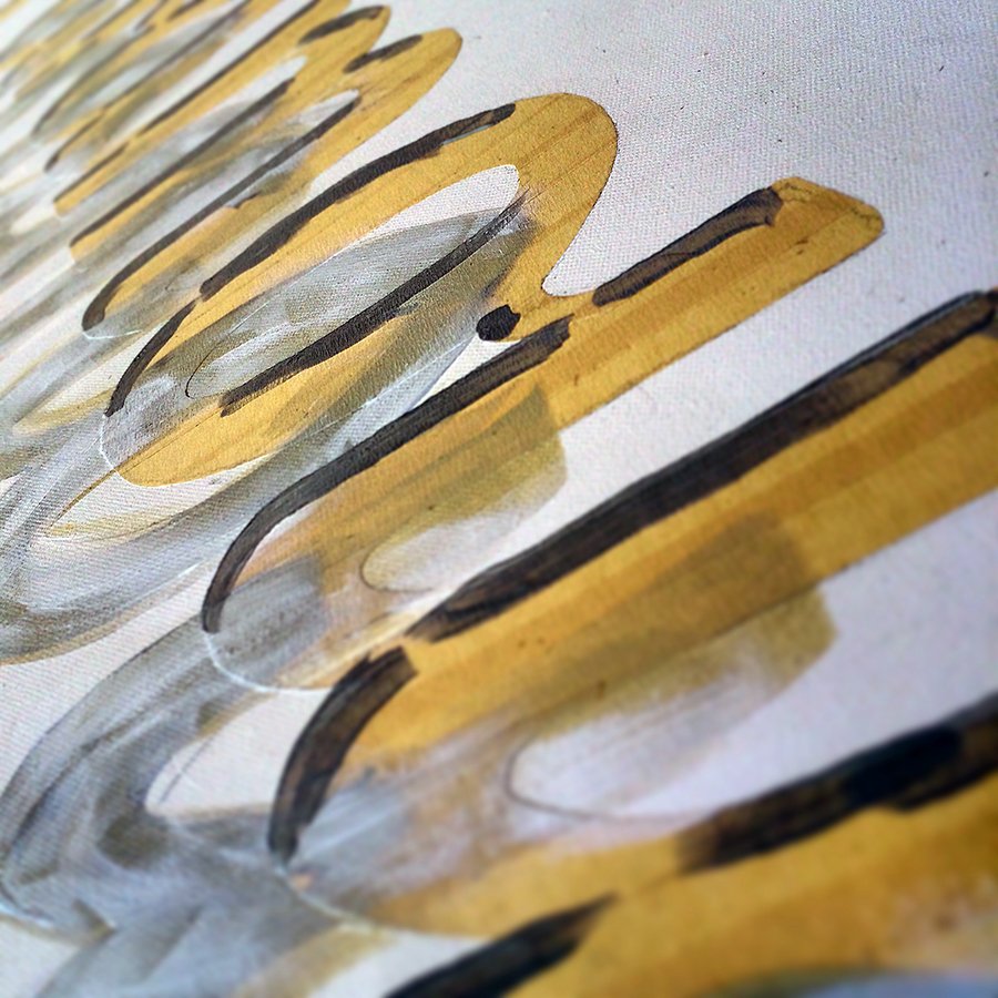 Close-up view of a painted surface with abstract yellow, white, and black strokes.