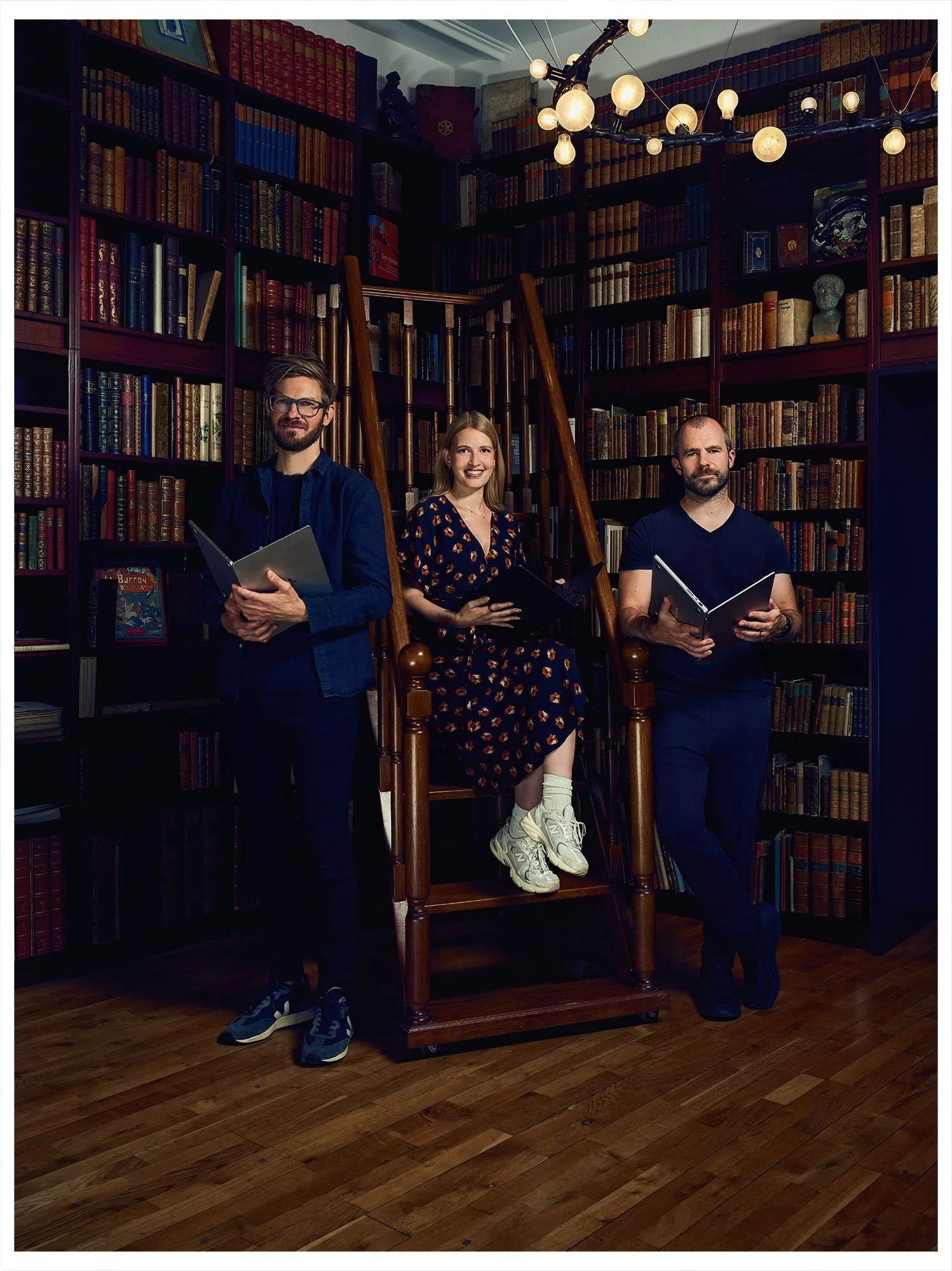 DeepJudge founders Kevin Roth, Paulina Grnarova and Yannic Kilcher portrayed in a library for the TOP 100 Swiss Startup Magazine 2026.