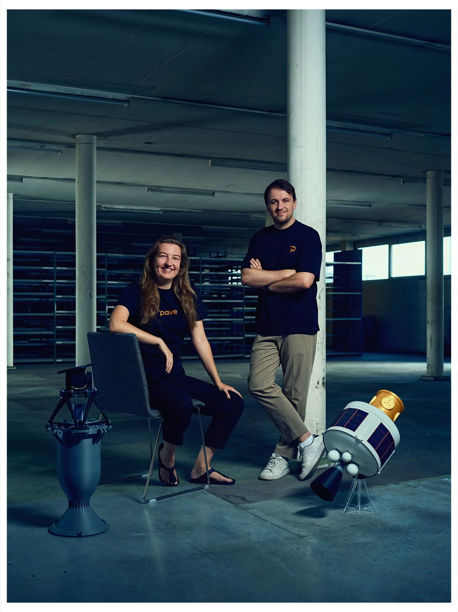 PAVE Space founders Julie Böhning and Jérémy Marciacq with spacecraft prototypes, photographed for the TOP 100 Swiss Startup Magazine 2026.