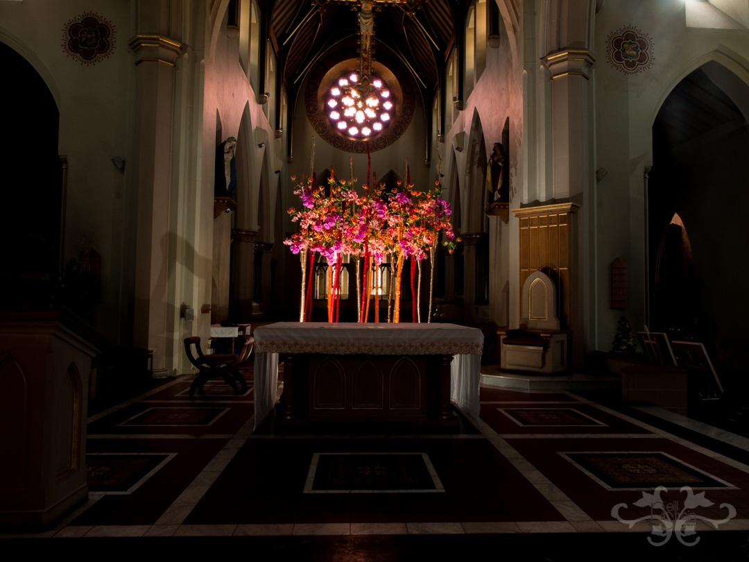 The rectilnear pattern on the floor of the high altar is repeated in the design with the placement of the birch trunks..