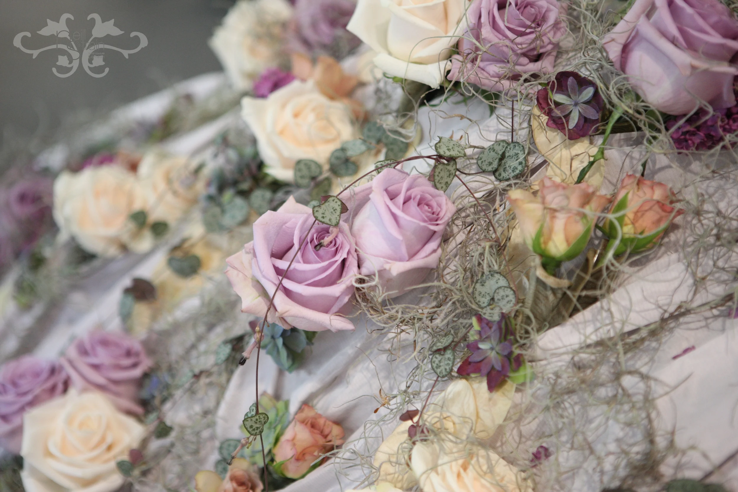 Roses, Spray Roses, Tillandsia, Eucalyptus and Cerepegia Woodi. .