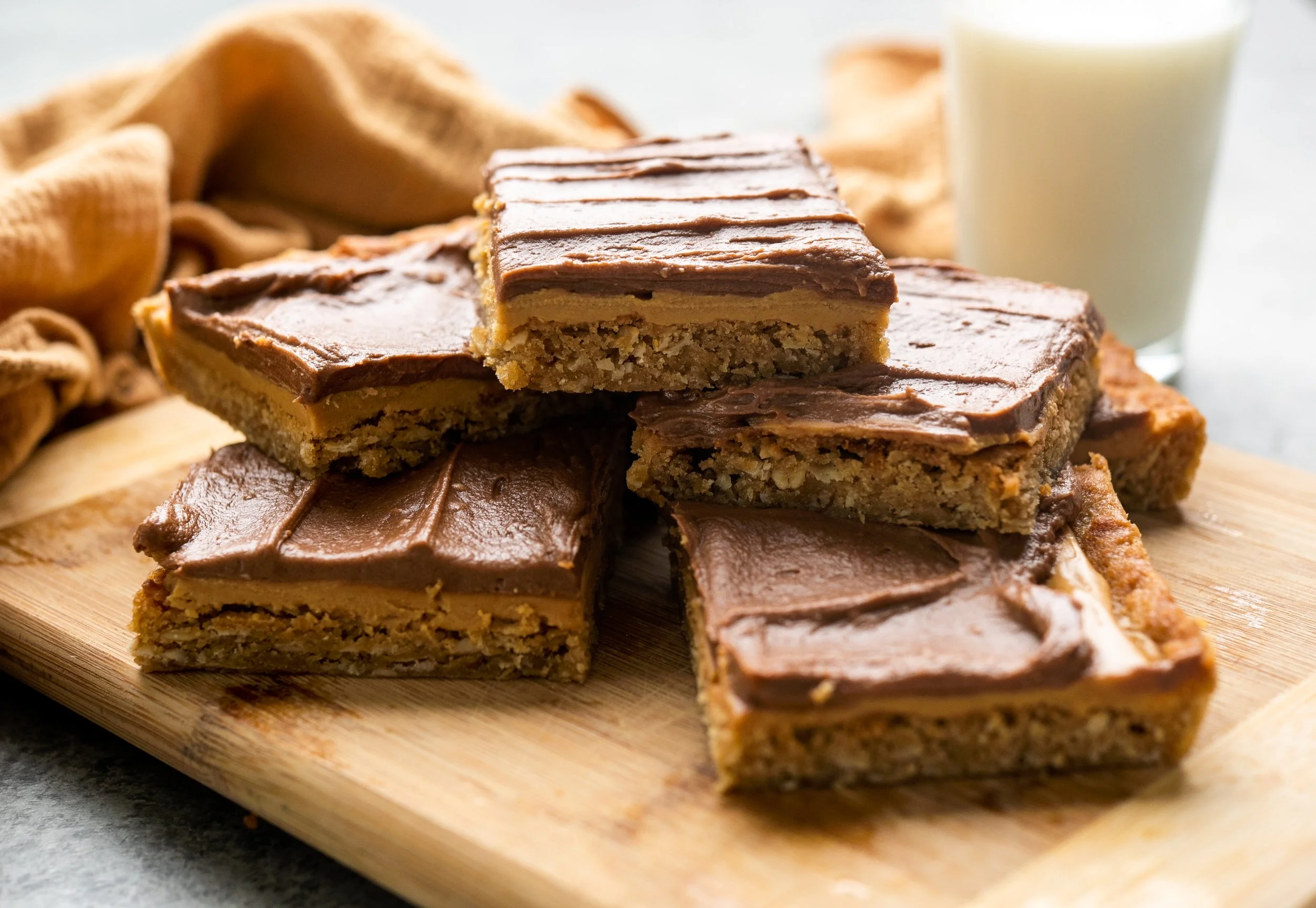 image of chocolate peanut butter bars and a glass of milk