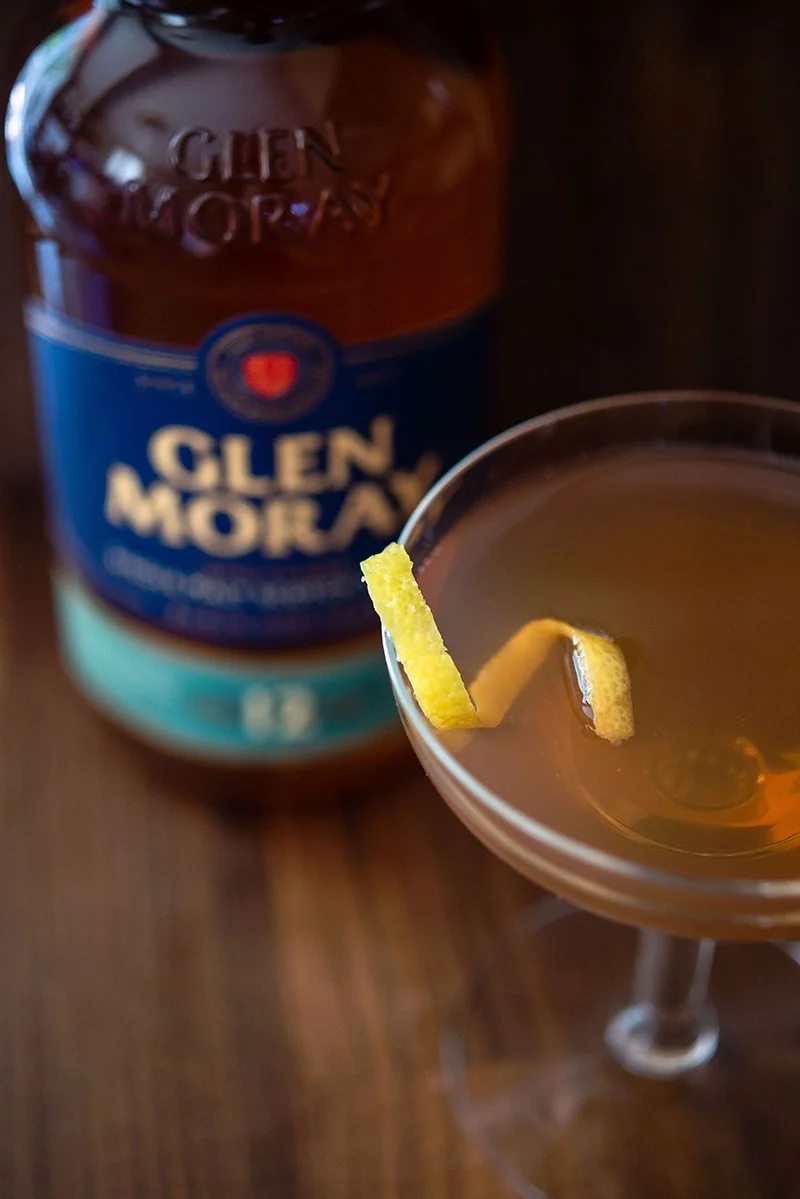 Glen Moray whisky bottle styled with a cocktail