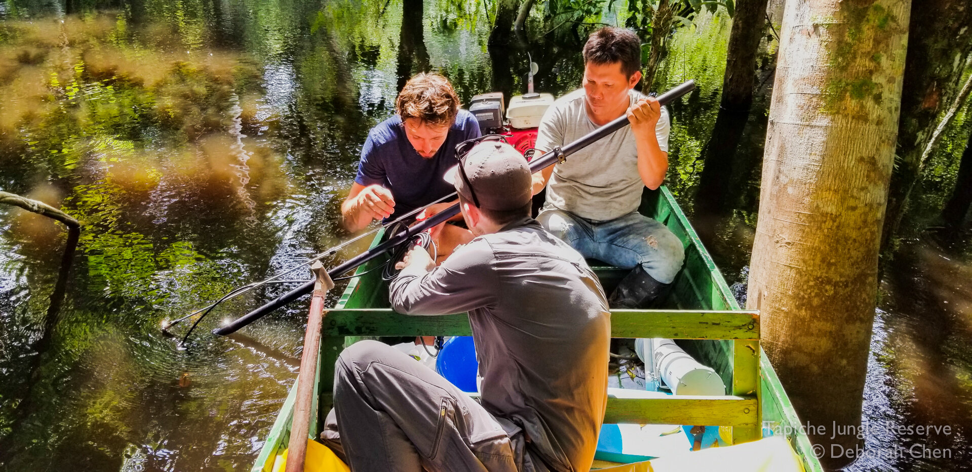  Cameraman Alex Vail, Tapiche guide Jose Murayari, and assistant producer Toby Nowlan prepare the underwater camera rig. 