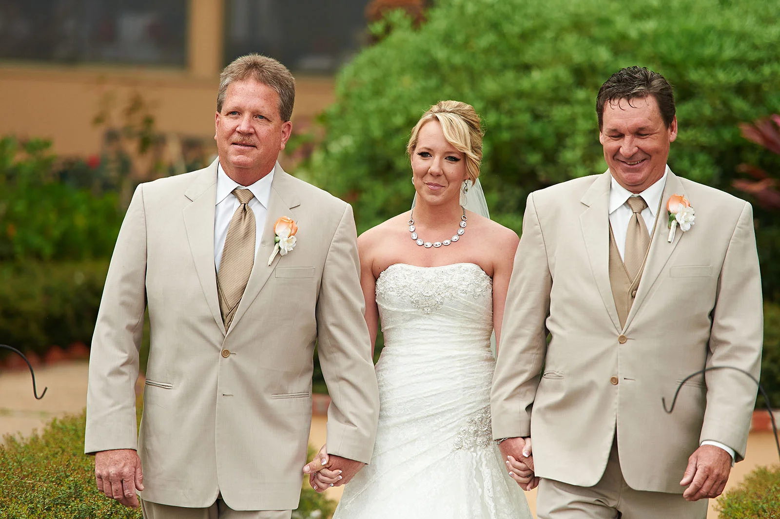 Ashlee walking down the aisle with her uncles.