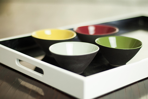 Lacquer tray with small conical dip bowls. The 50mm lens gave a wonderful soft background here, due to the low angle the wood appears much lighter than it is.