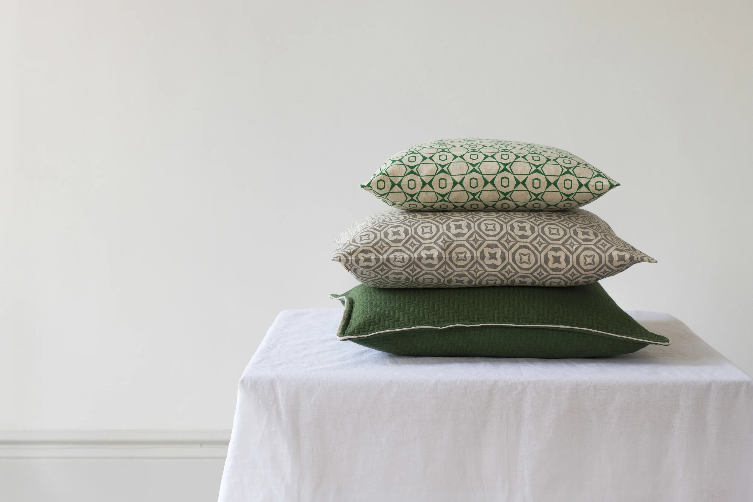 Products on table with white muslin in front of main wall