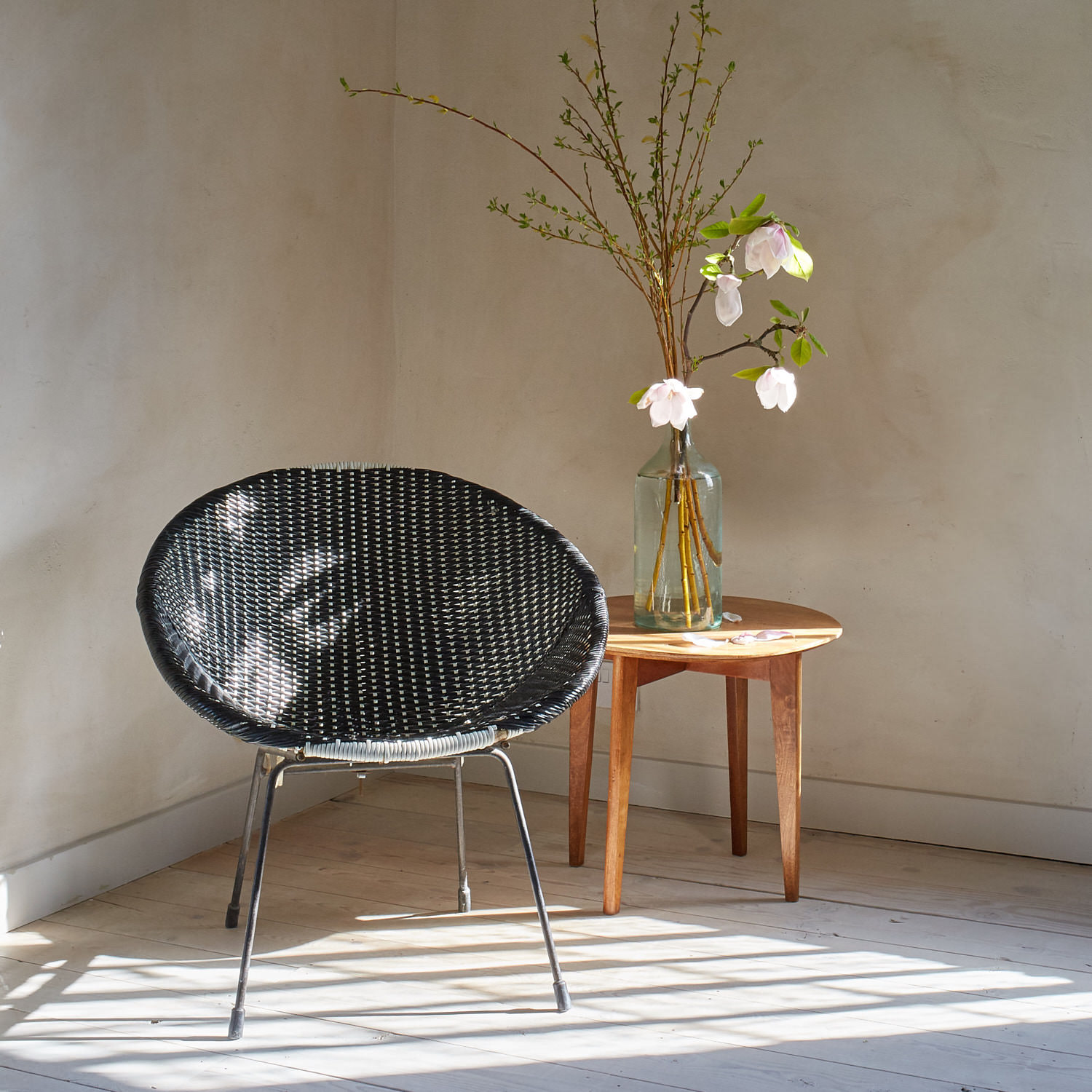 An unusual wicker chair sits nicely in the corner, we found some Magnolia to create a simple and calm scene. The chair is very comfortable too!
