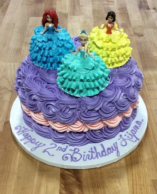 Round Cake Covered in Rosettes with Cupcake Dresses