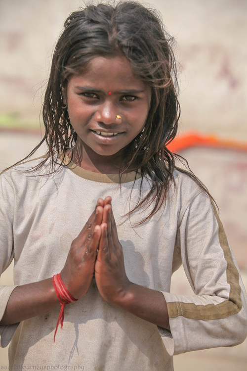 children child looking straight prayer pose Varanasi.jpg
