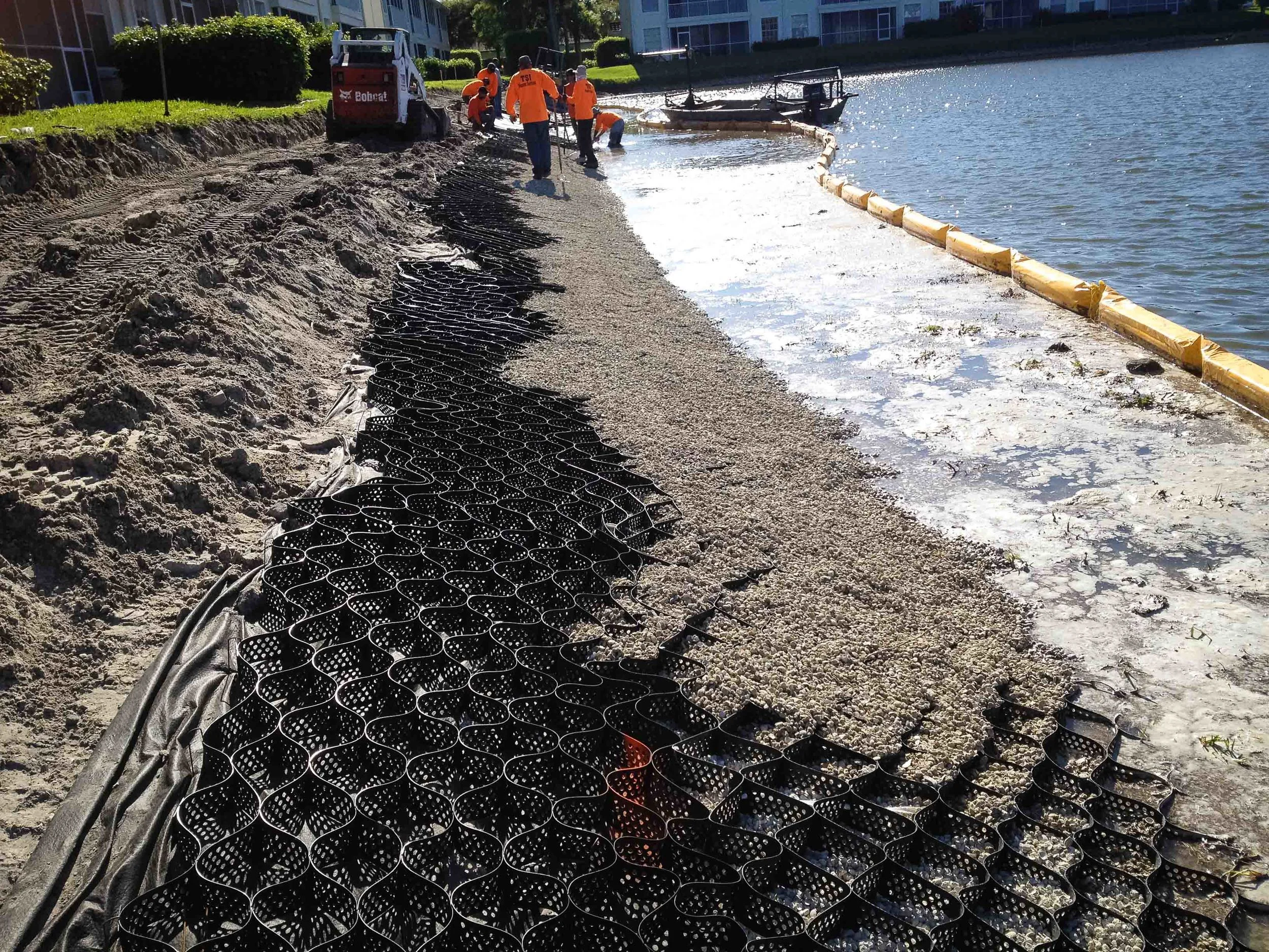 Filling geocell matrix with 57 stone.