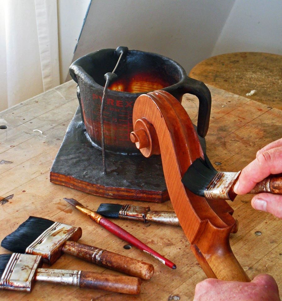 Varnishing a cello scroll