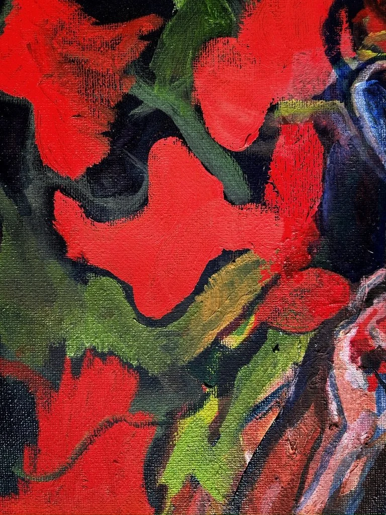 Close-up of a colorful abstract painting with red, green, and dark blue brushstrokes.