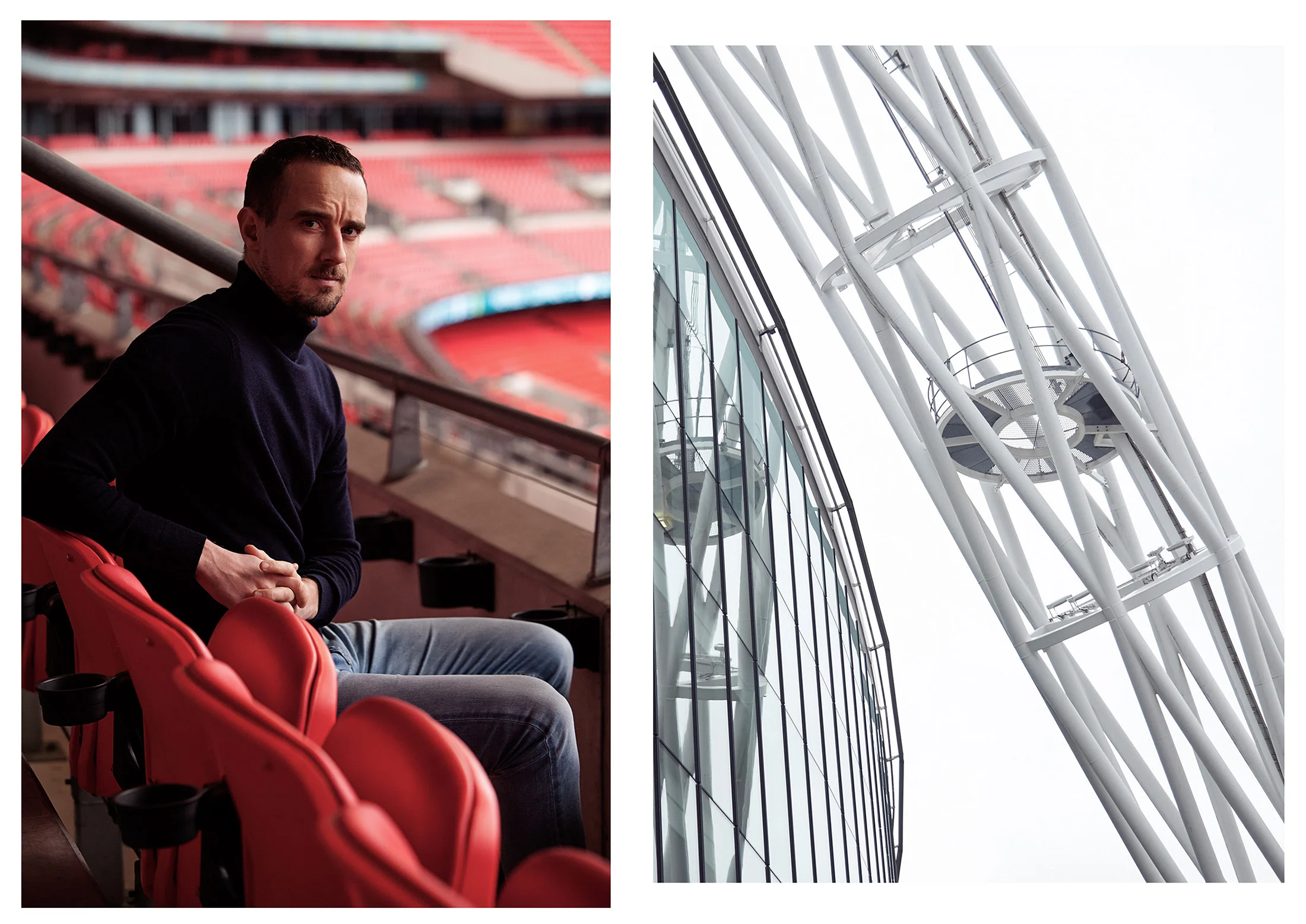 A man sitting in a stadium with red seats on the left side, and a modern glass building with a tall white structural tower on the right side.