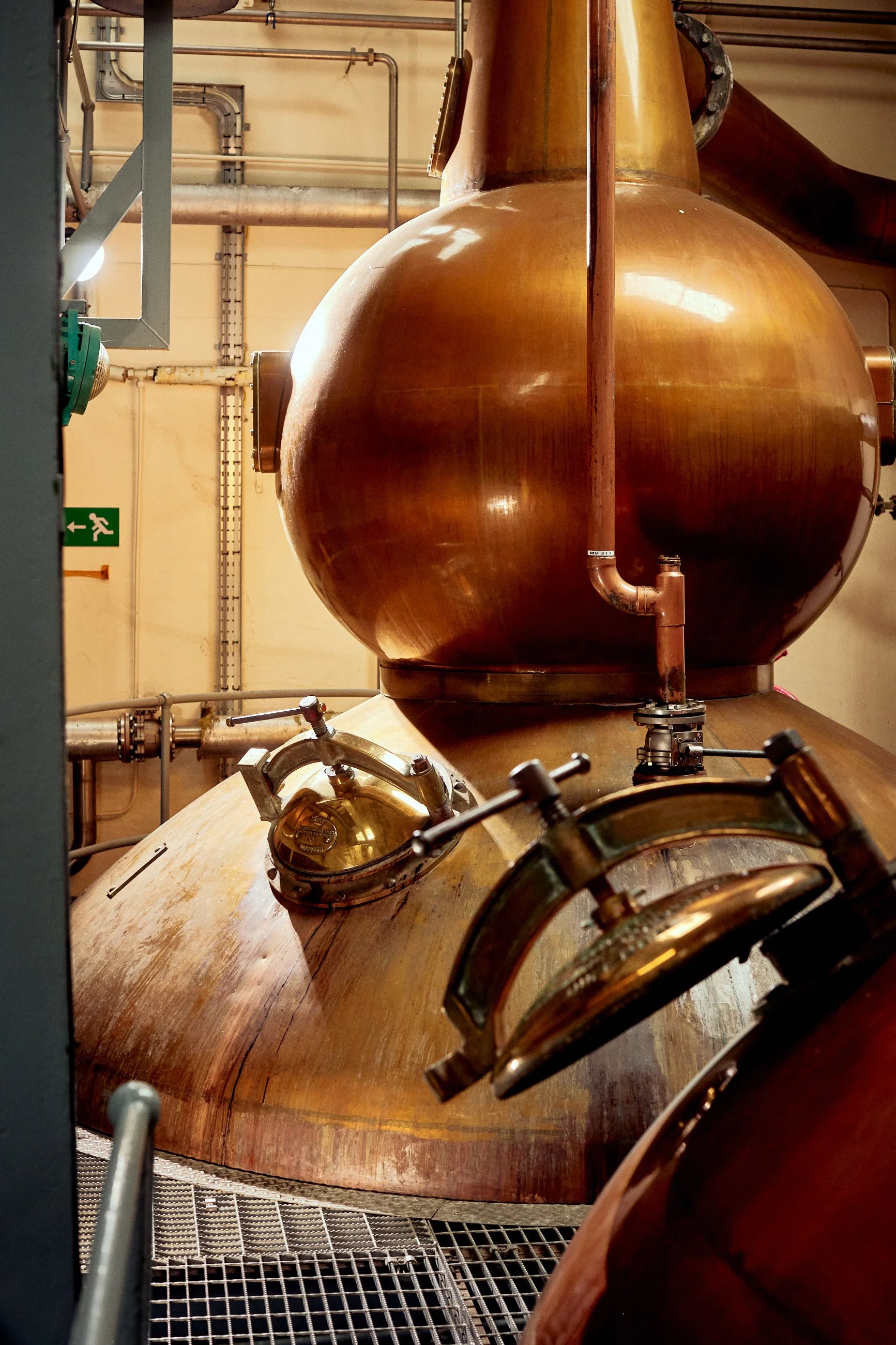 Copper still used for distillation or brewing in an industrial setting