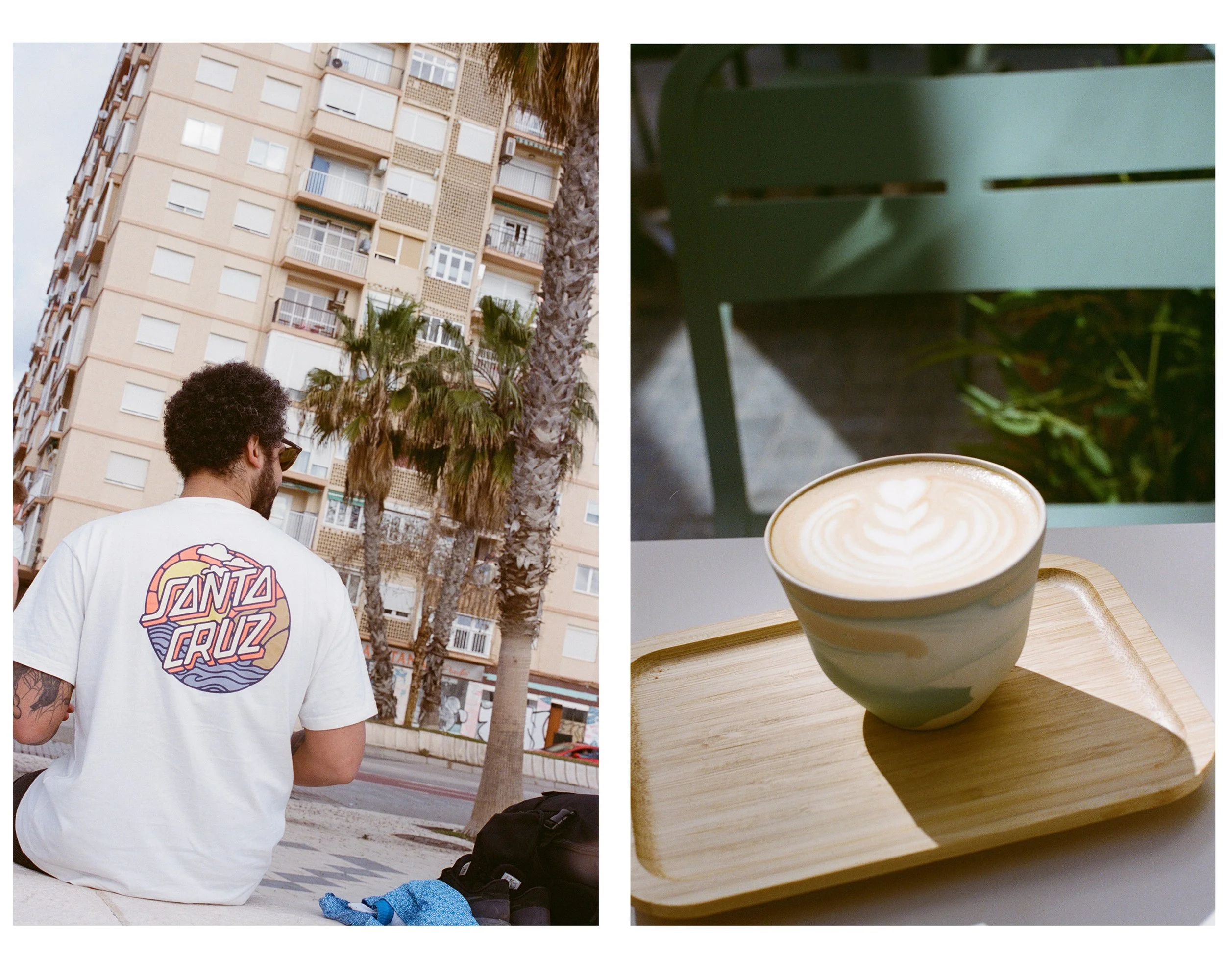 A person with curly hair wearing a white T-shirt with a colorful Santa Cruz logo on the back, sitting on a curb in an urban setting with palm trees and tall apartment buildings. Next to it, a latte with latte art on top is placed on a wooden tray on 