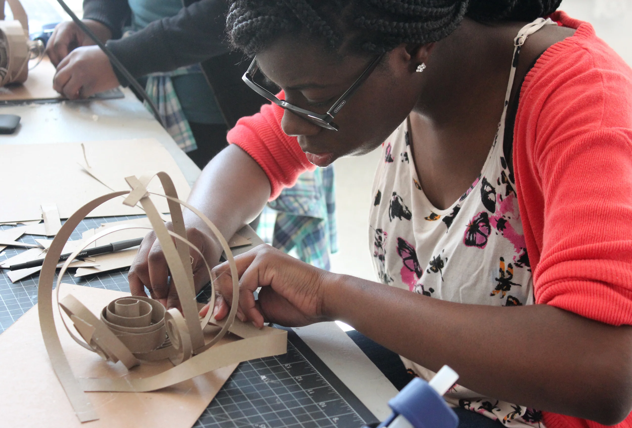 Hope High School, Providence Senior Portfolio student Jessica begins to construct her self-portrait in cardboard inspired by random adjectives.