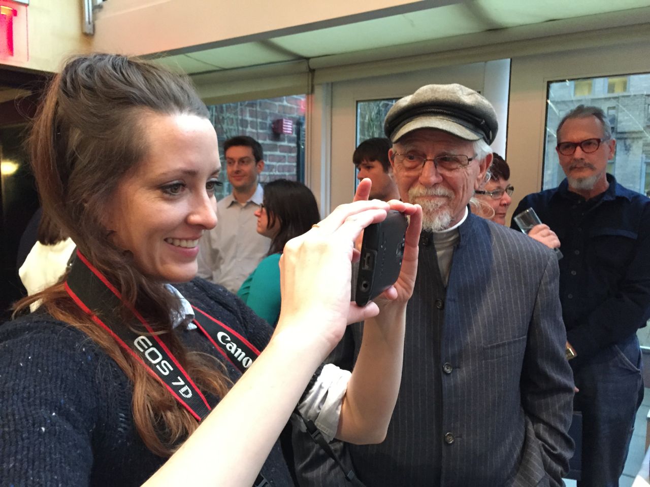 Charli James (@Charli), a video producer/journalist taking a picture of her parents with her grandfather looking on. 