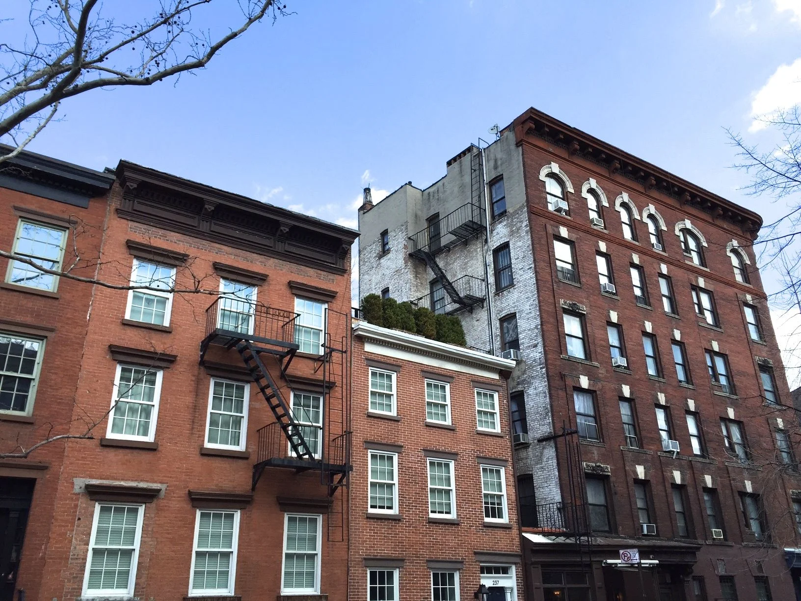 There seem to be a few open windows in the large building at the far right. 