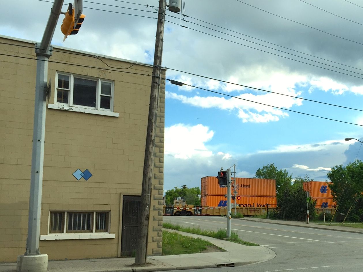 Those orange things are on a moving freight train which goes right into the city. I was told that sometimes these trains can be several miles long. (italics not ennabled in comments or there'd be plenty of them in this caption)