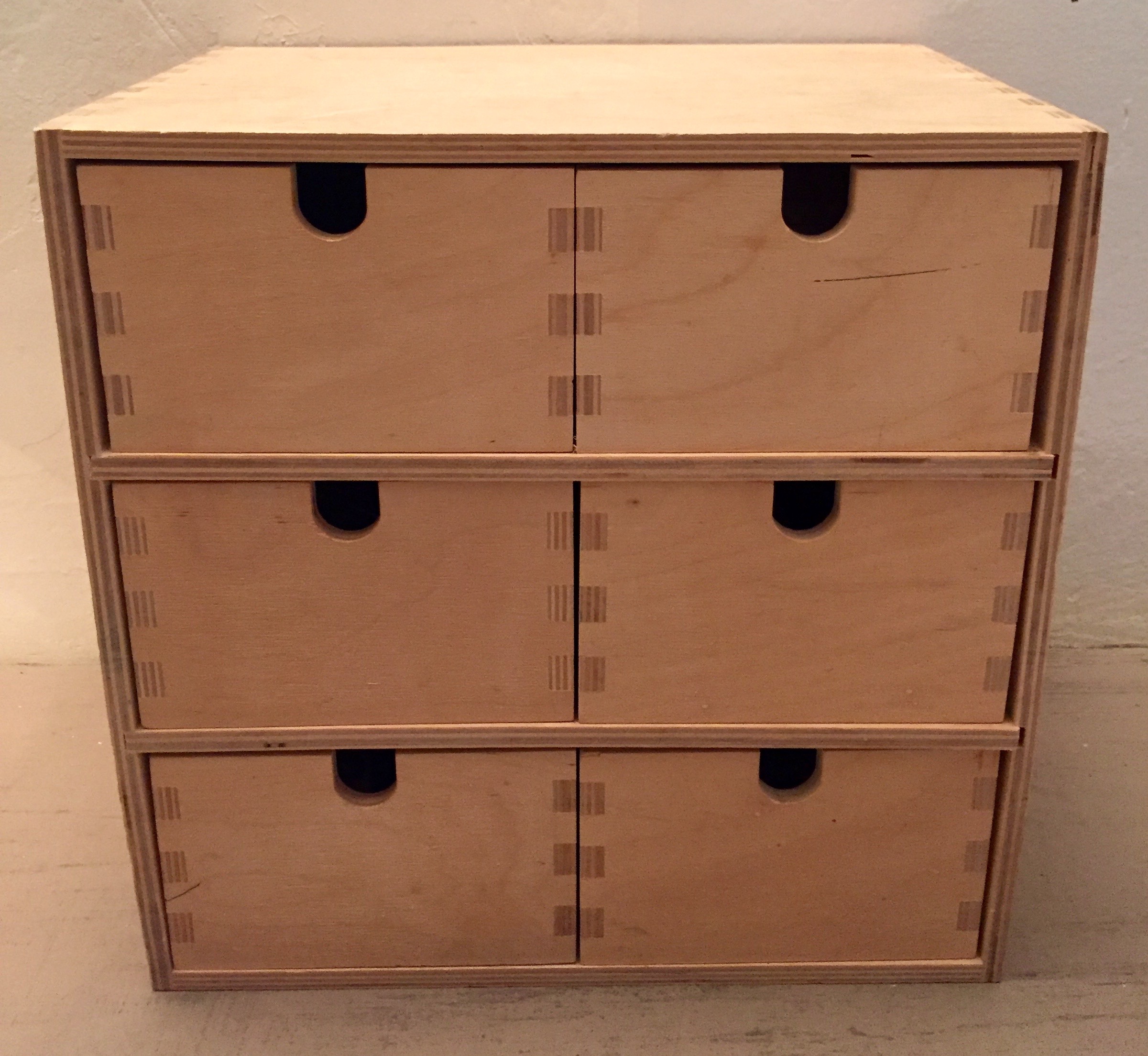 We got this at Ikea in around 2000 to organize the clutter of pens and paper clips. You could substitute any strong box of the right height. 