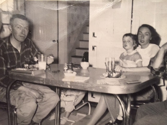 On my mother's lap, wearing tap shoes.