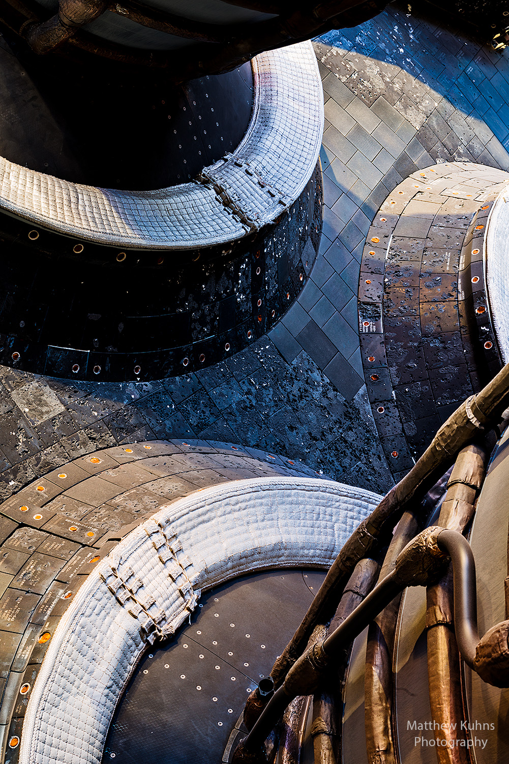 Detail image of the gimbling main engine mounts on the back of the orbiter. Amazing technology in this image, panels capable of handling thousands of degrees on re-entry, engines with internal temperatures reaching 6000 deg F, computer controlled thrust vectoring to ensure stable flight on launch. With over 2.5 million parts, the Space Shuttle truly is an engineering marvel. 