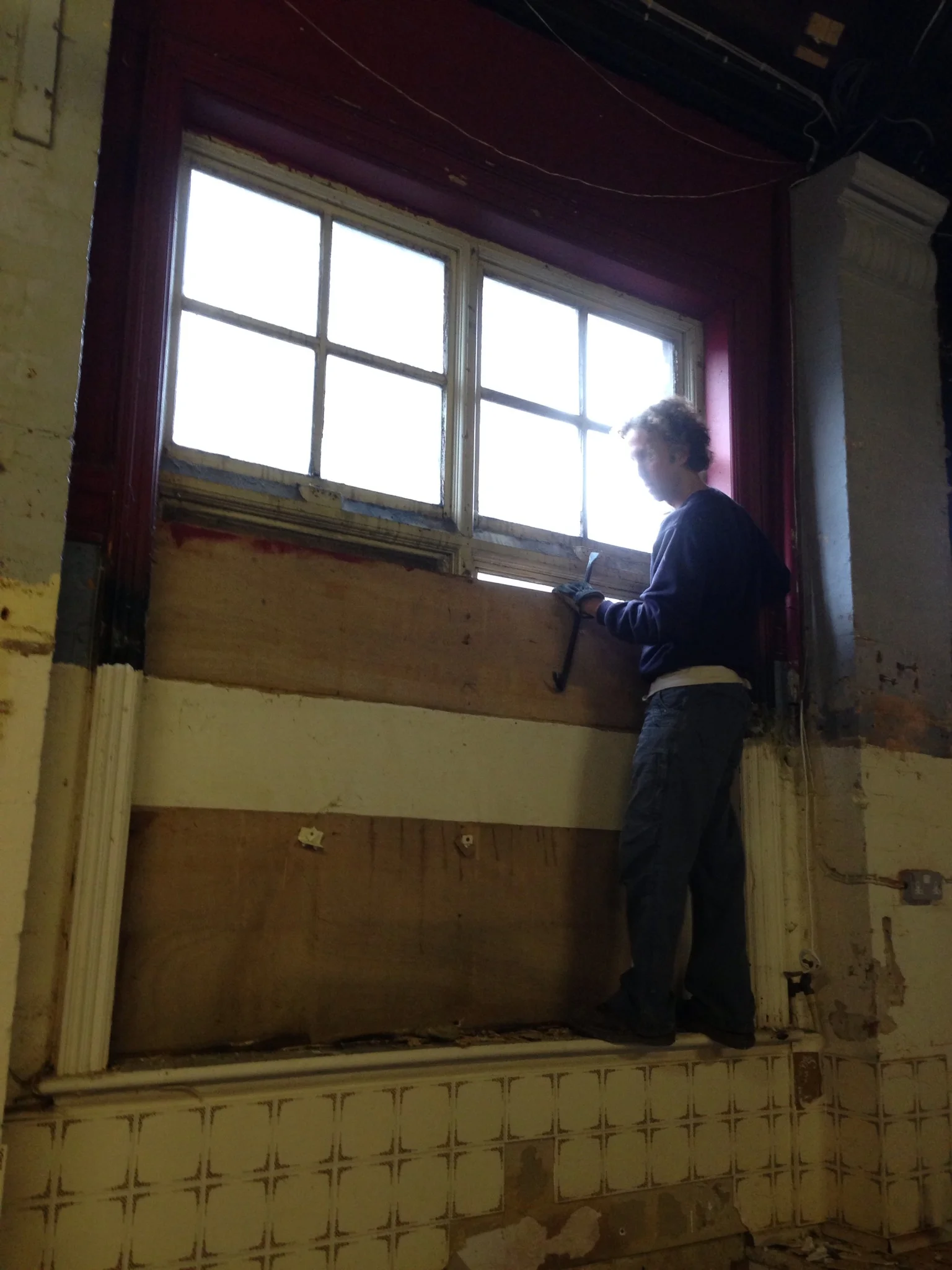 Un-boarding the window to let the fist bit of natural light into The Hall for 60 years.