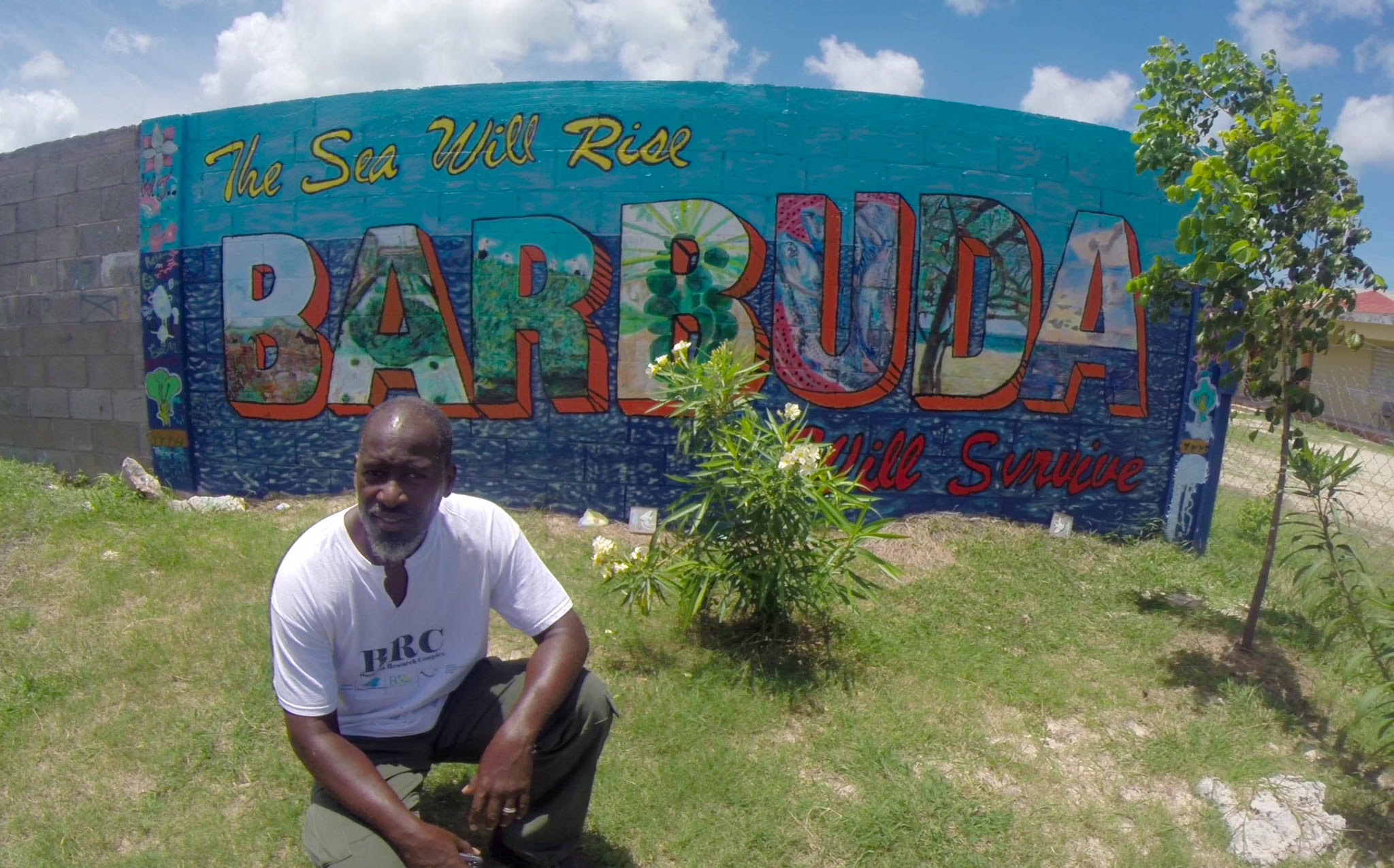 John Mussington,co-founder BRC, in front of a mural, painted as part of a children's climate education program.